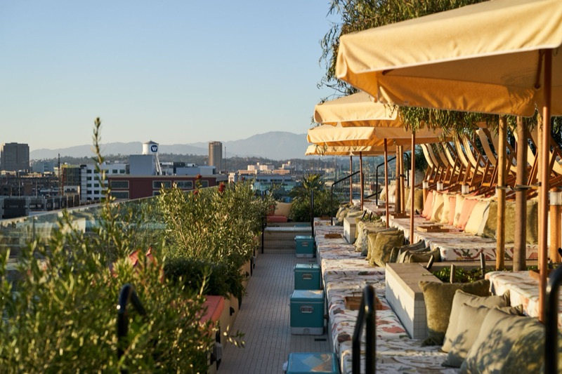 The rooftop pool at Soho Warehouse with the Downtown Los Angeles skyline behind it.